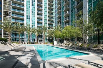 A large swimming pool in front of an apartment building